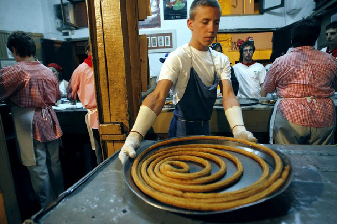 Приготовление испанского чурроса (churros) во время фестиваля Сан Фермин в Памплоне, 9 июля 2010 года.