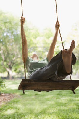 7467202-a-young-woman-is-swinging-on-a-swing-in-a-park-setting--vertical-shot (267x400, 23Kb)